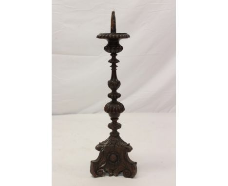 17th / 18th century Italian carved walnut ecclesiastical pricket candlestick, knopped fluted form on spread tri-form base wit
