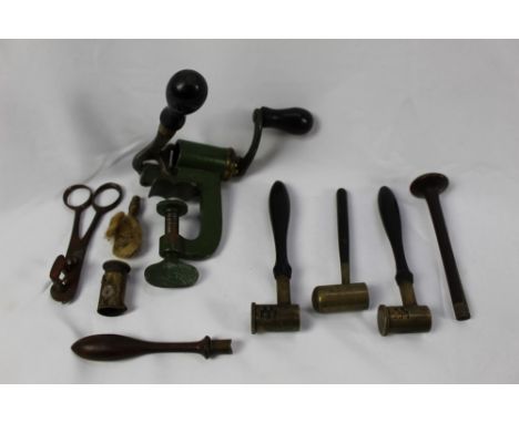 An antique cartridge reloading tool, three brass shot and powder measures with wooden handles and other similar items