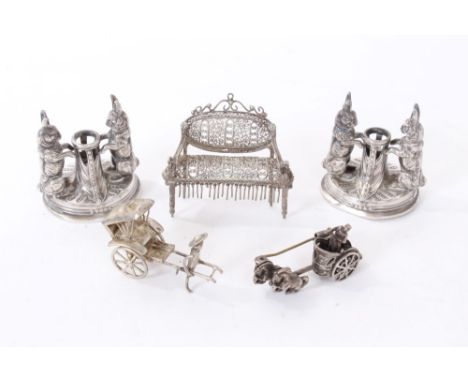 A group of white metal items, including a pair of novelty white metal miniature taper sticks, each in the form of two hares, 