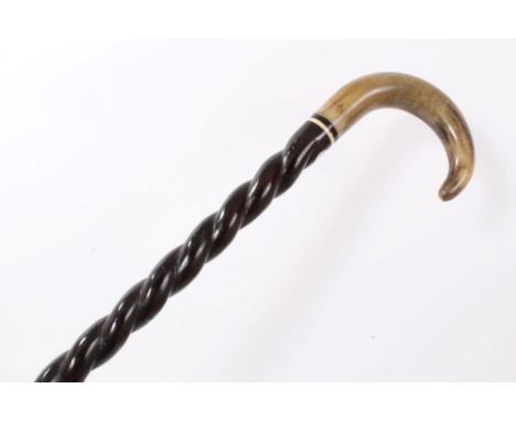 Late 19th century heavy walking stick with twisted ebonised shaft inset with ivory washer and horn crook handle, 92cm overall