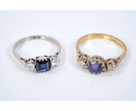 Sapphire and diamond three stone ring with a central square stepped cut blue sapphire flanked by a brilliant cut diamond to e