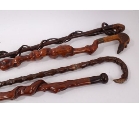 Antique entwined honeysuckle walking stick, 97cm long, together with a naturalistic honeysuckle stick with snake wood handle,