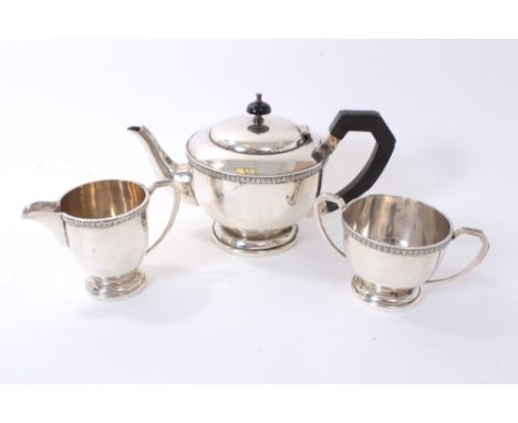 1940s silver three piece teaset, comprising teapot of cauldron form, with leaf and dart border, angular ebony handle and hing