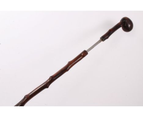 Antique wooden sword walking stick, with club handle and naturalistic finish, 86cm long