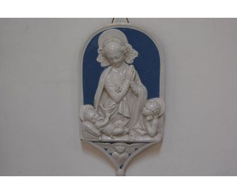 A Cantagalli&nbsp; plaque in the style of Della Robbia depicting the Virgin and child with cockerel mark verso .(35cm x 20cm)