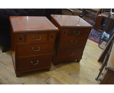 A pair of Eastern hardwood bedside/ lamp tables, the square tops with moulded edge above an arrangement of one short and two 