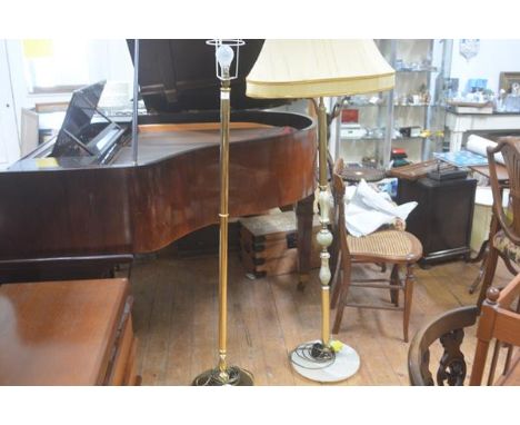 A brass circular column floor lamp raised on circular weighted base and a 1970s onyx and brass fluted floor lamp complete wit