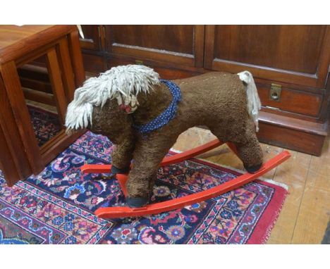 A plush child's miniature rocking horse raised on red scroll rockers (h.54cm x 69cm)