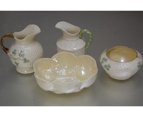 A collection of Irish Belleek porcelain including a shell shaped scalloped dish with green back stamp, a clover leaf decorate