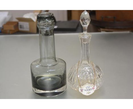A modern 20thc Caithness smoked glass decanter complete with stopper (h.26cm), an Edwardian crystal slice cut sherry decanter