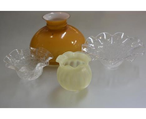 Two moulded crimped glass light shades, an orange to clear oil lamp style dome shade and a vaseline crimped bordered circular