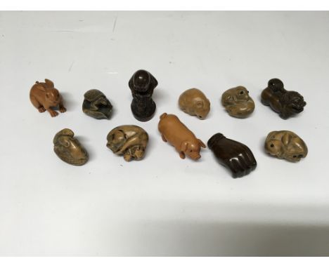 A group of 11 Netsuke figures of animals and people.