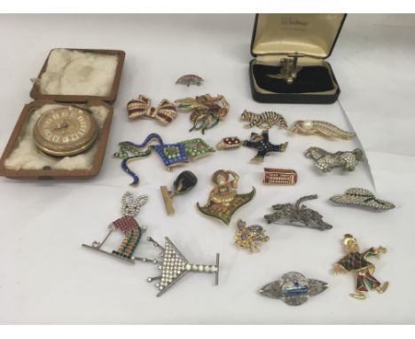 A collection of decorative brooches and a gilt button wind pocket watch