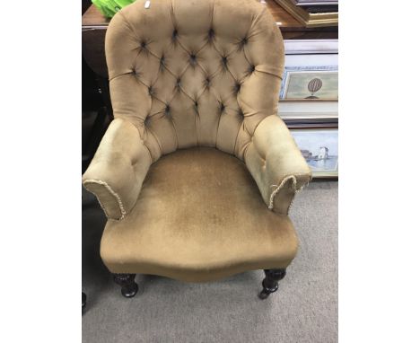 A Victorian button back chair on turned fluted legs
