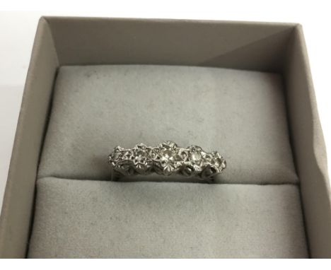 A gold and platinum ring set with a band of five diamonds.Approx Q/R
