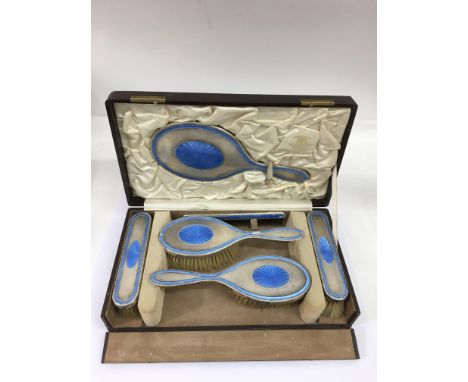 A fine silver and blue enamel brush set, hallmarks for Goldsmiths &amp; Silversmiths Co., Sheffield, presented in fitted case