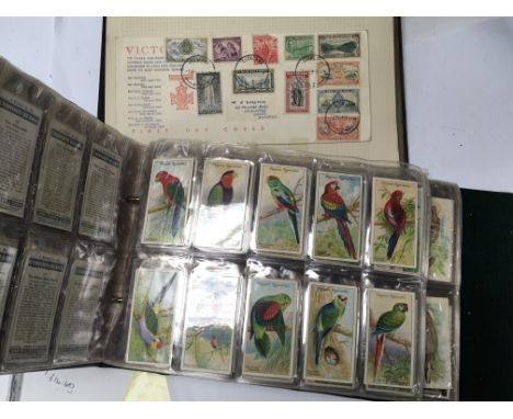 An Album containing cigarette cards including exotic birds and animals and a Stamp Album. (2)