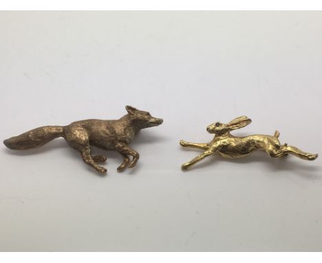 Two Harriet Glen 9ct gold brooches comprising a fox with ruby eyes and a hare with sapphire eyes, approx 18g.
