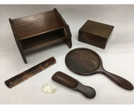 A mahogany Asprey bookshelf, tortoiseshell comb, mother of pearl brooch and other items.