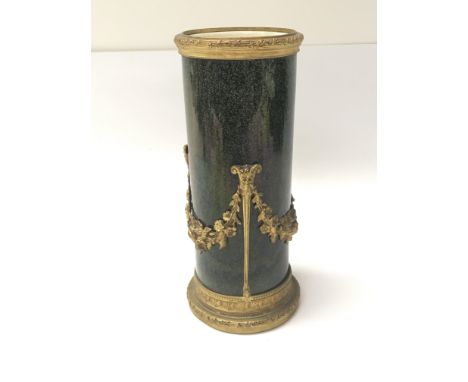 A 19th century French Serves Porcelain vase with a powder green glaze and applied gilt metal mounts, height 19cm.