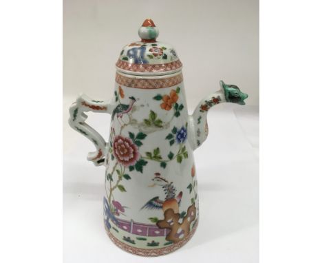 A Chinese porcelain teapot, the handle and spout formed as a dragon, painted in polychrome enamels with a landscape scene.App