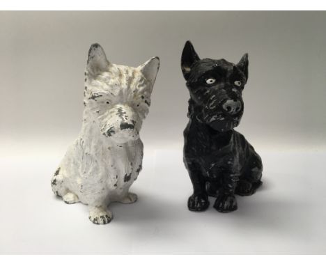 A pair of painted black and white cast metal Scotch Whisky dogs, approx 20cm.
