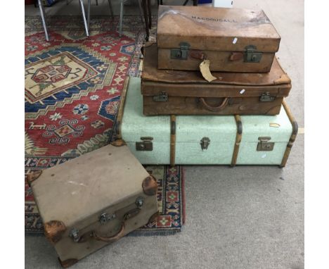 A vintage travelling trunk, two leather suitcases and one other canvas case.