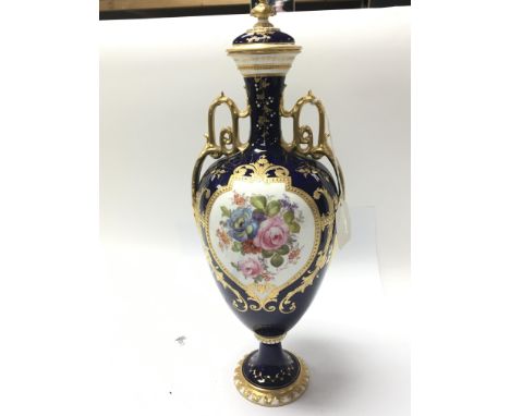 A Quality Royal Crown Derby hand painted porcelain vase with panels of flowers. Signed C Harris. With applied gilt on a deep 