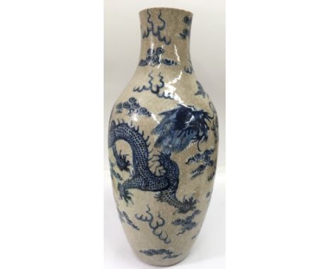 A large Chinese crackleware vase painted with a blue five claw dragon.Approx 55cm high, top cut down, drilled base