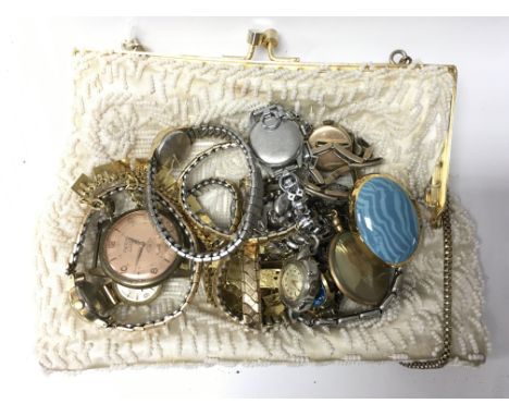 A ladies purse containing a collection of wristwatches, to include examples by Delco, Timex and Tissot.