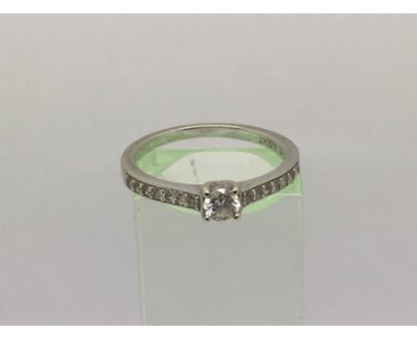 A 9ct white gold diamond ring, the central stone with smaller diamonds set to the shoulders, approx 0.5ct, approx 2.5g and ap