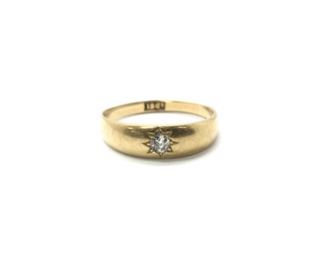 An 18ct gold ring set with a central diamond, gypsy ring style. Total weight approx 4 grams, ring size R.