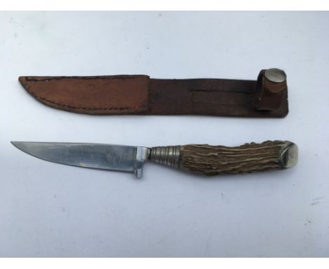 A German Hunting knife with Hugo Koller solingen Marks. Blade length approx 11cm, 22cm total length. With leather scabbard,