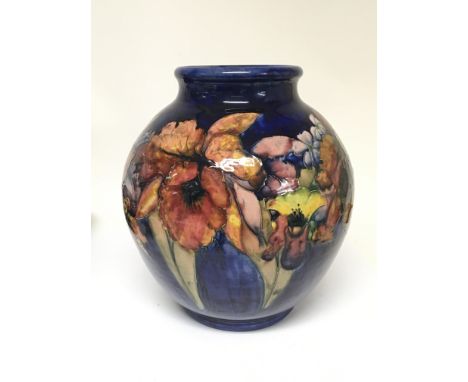 A large and impressive 1930s William Moorcroft signed vase with Orchid on a deep blue ground. No damage or restoration. Heigh