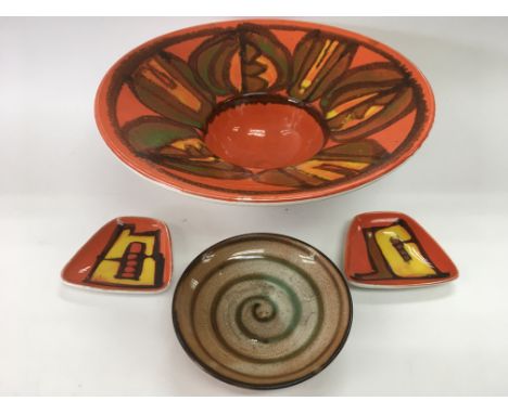 Four Poole pottery items.