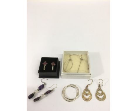 Five pairs of silver earrings including a ruby and pearl set pair