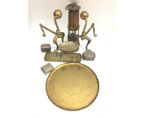A collection of brass oddments to include a lamp, fire dogs and a crib board.