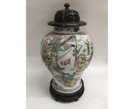 A 19th Century Chinese vase of baluster form and painted with a central pair of male and female figures being entertained by 