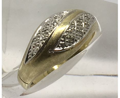 An 18ct gold ring set with small diamonds, 0.0.9.Approx O