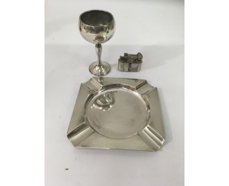 A silver ash tray together with silver stem cup and lighter