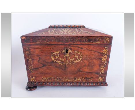 A Regency Inlaid Rosewood Hinge Lidded Tea Caddy Of Sarcophagus Shape, fitted with 2 lidded compartments with brass inlay. A 