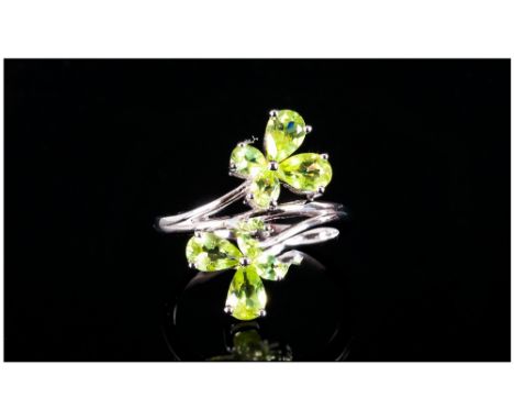 Peridot Butterfly Crossover Ring, each end of the crossover shank of rhodium vermeil and silver set with a peridot butterfly 