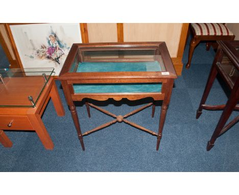 Mahogany Display Curio Cabinet, with glazed edge top, supported on turned legs. With bucket feet. With a shaped stretcher wit