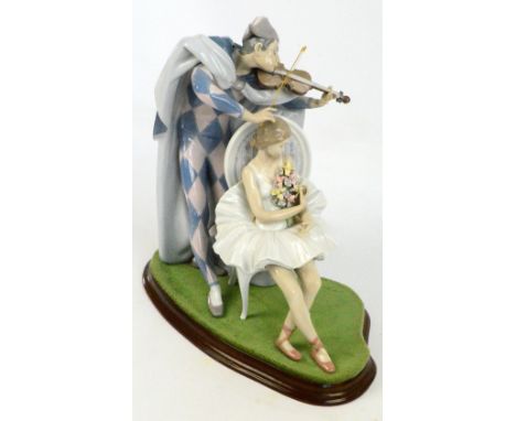 A large Lladro figure group of a seated ballerina with flowers and a jester standing beside her playing a violin, height 39cm