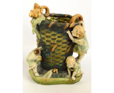 A large Amphora jardinière modelled as three children playing beside a cane work basket, impressed marks to base, height 43cm