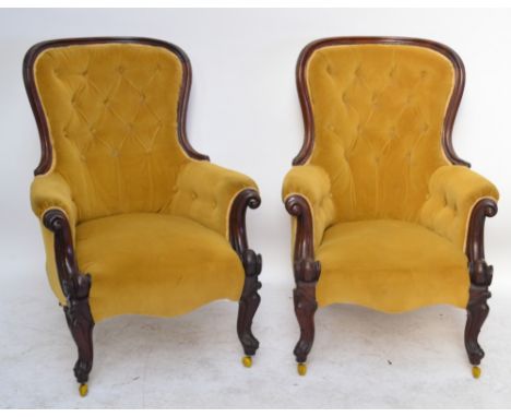 A pair of Victorian mahogany spoon back chairs, each shaped top rail with button upholstered back, scrolling padded arms, stu