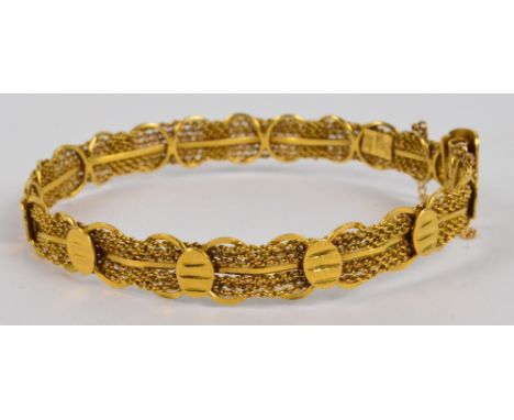 A 22ct yellow gold mesh bangle, with safety chain, oval 6.5 x 6cm, approx 20.4g.