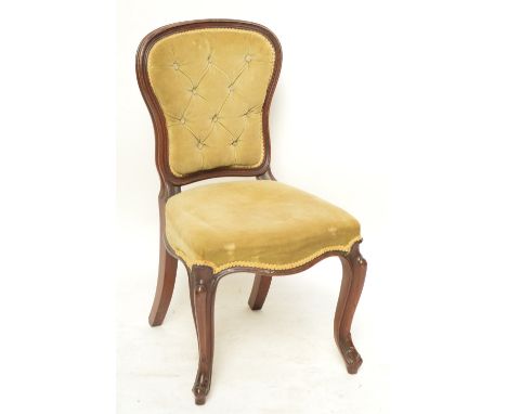 A mahogany button upholstered spoon back dining chair with cabriole legs.