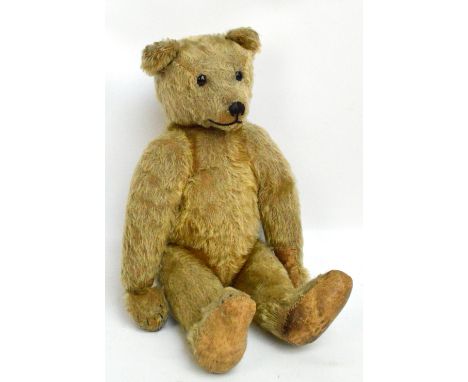 An early 20th century English teddy bear with button eyes, pointed snout, and hump back, height 46cm. CONDITION REPORT: Origi