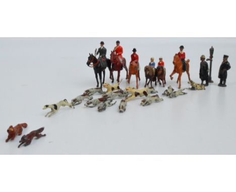 A playworn diecast Britain's hunting set comprising two riders on horses, two riders on ponies, eleven hounds and a fox, also